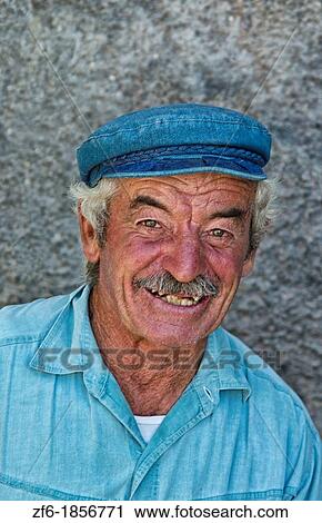 Stock Image - Portrait of rough fisherman in village of Fira in Santorini Greece in Greek Islands. Fotosearch