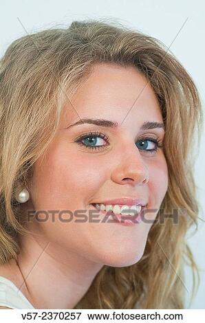 Portrait of young woman smiling and looking at the camera. Close view. View Large Photo Image Stock Photo - Portrait of young woman smiling and looking at the camera. Close view.. Fotosearch