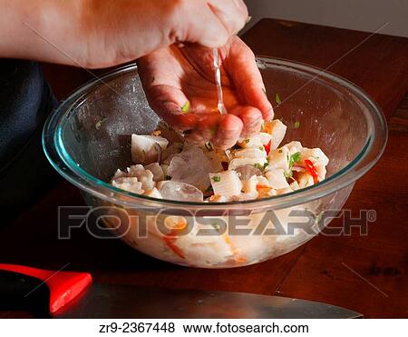 Stock Photo - "Preparing Ceviche with fresh vegetables and raw fish, Cooking class, Bellavista district, Santiago, Chile, South America. ". Fotosearch