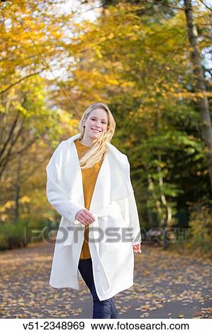 Pretty blonde young woman walking in Park and smiling at camera View Large Photo Image Stock Photo - Pretty blonde young woman walking in Park and smiling at camera. Fotosearch