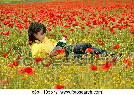 Reading a book in a poppies field. View Large Photo Image Stock Photo - Reading a book in a poppies field.. Fotosearch
