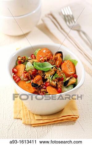 Stock Image - Salad with mussels and pomegranates. Fotosearch