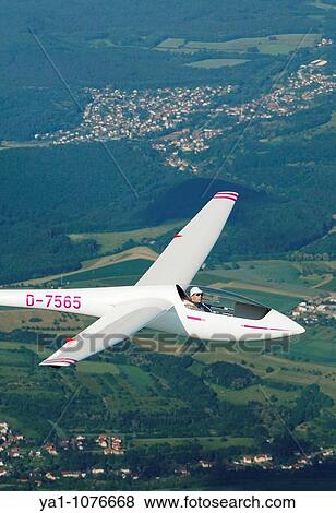 Stock Photo - Single seat glider Asw 19b in flight over french Lorraine countryside - France. Fotosearch