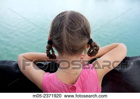 Stock Image - Six year old girl watching the sea.. Fotosearch