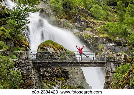 Stock Photo - "Slow shutter speed silky water of the Olden River and bridge as it flows along Briksdalen, Olden, Nordfjord, Norway. ". Fotosearch