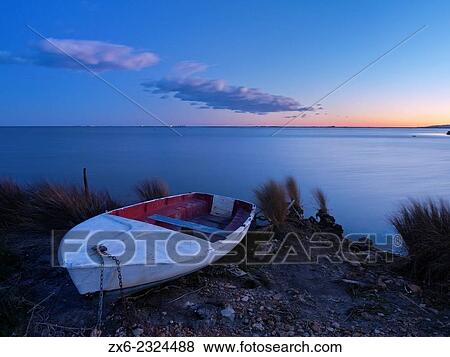"Small fishing boat at Alfacs Bay in twilight. Ebro River Delta Natural Park, Tarragona province, Catalonia, Spain. " View Large Photo Image Stock Photo - "Small fishing boat at Alfacs Bay in twilight. Ebro River Delta Natural Park, Tarragona province, Catalonia, Spain. ". Fotosearch