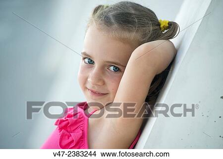 Picture - Small girl posing as a model in a garden. Fotosearch