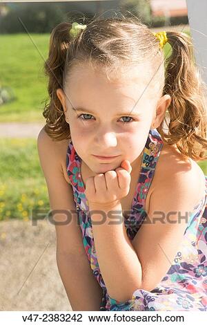 Small girl posing as a model in a garden View Large Photo Image Stock Image - Small girl posing as a model in a garden. Fotosearch