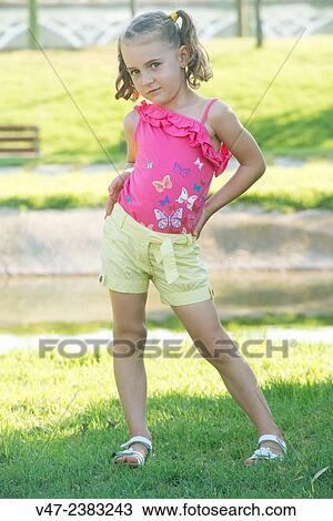 Small girl posing as a model in a garden View Large Photo Image Stock Image - Small girl posing as a model in a garden. Fotosearch