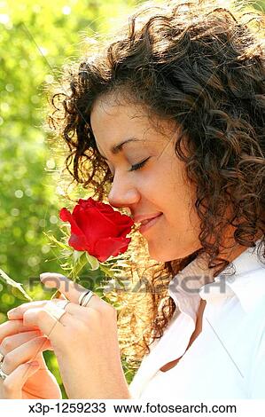 Smelling a rose View Large Photo Image Stock Image - Smelling a rose. Fotosearch