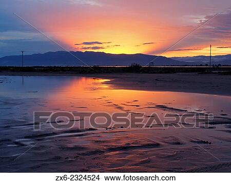"Sun sets behind Montsia Hills after a rainstorm. Trabucador Isthmus. Ebro River Delta Natural Park, Tarragona province, Catalonia, Spain. " View Large Photo Image Picture - "Sun sets behind Montsia Hills after a rainstorm. Trabucador Isthmus. Ebro River Delta Natural Park, Tarragona province, Catalonia, Spain. ". Fotosearch