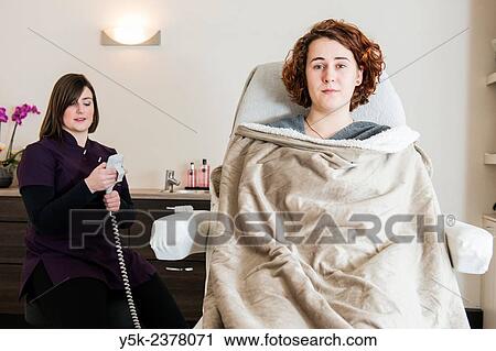 Stock Image - "Tilburg, Netherlands. Female beautician and her new customer preparing for a session in her beauty salon. ". Fotosearch