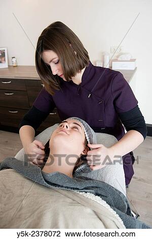 Stock Image - "Tilburg, Netherlands. Female beautician and her new customer preparing for a session in her beauty salon. ". Fotosearch