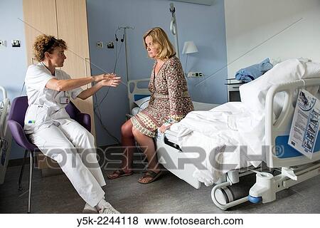 "Tilburg, Netherlands. Physio therapist instructing a female post operative patient on how to walk again, after reviving a new hip in surgery. " View Large Photo Image Stock Photo - "Tilburg, Netherlands. Physio therapist instructing a female post operative patient on how to walk again, after reviving a new hip in surgery. ". Fotosearch