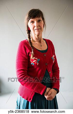 Stock Photo - "Tilburg, Netherlands. Studio portrait of a 61 year old colorful dressed and fashionable woman. ". Fotosearch
