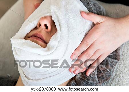"Tilburg, Netherlands. Young beautician wrapping her customers face in a warm, most towel. " View Large Photo Image Stock Image - "Tilburg, Netherlands. Young beautician wrapping her customers face in a warm, most towel. ". Fotosearch