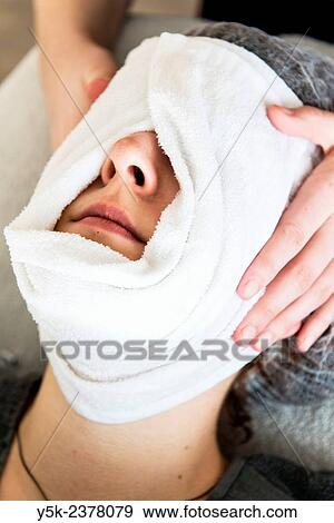 "Tilburg, Netherlands. Young beautician wrapping her customers face in a warm, most towel. " View Large Photo Image Stock Photo - "Tilburg, Netherlands. Young beautician wrapping her customers face in a warm, most towel. ". Fotosearch
