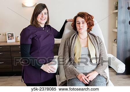 "Tilburg, Netherlands. Young beautician and her customer, just after initial cleansing of her facial skin. " View Large Photo Image Stock Photography - "Tilburg, Netherlands. Young beautician and her customer, just after initial cleansing of her facial skin. ". Fotosearch