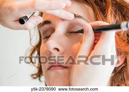"Tilburg, Netherlands. Young, brunette beautician applying male up to her customers face. " View Large Photo Image Stock Image - "Tilburg, Netherlands. Young, brunette beautician applying male up to her customers face. ". Fotosearch