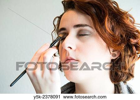"Tilburg, Netherlands. Young, brunette beautician applying male up to her customers face. " View Large Photo Image Stock Image - "Tilburg, Netherlands. Young, brunette beautician applying male up to her customers face. ". Fotosearch