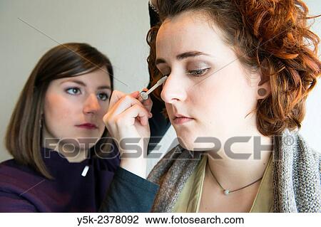 "Tilburg, Netherlands. Young, brunette beautician applying male up to her customers face. " View Large Photo Image Stock Image - "Tilburg, Netherlands. Young, brunette beautician applying male up to her customers face. ". Fotosearch