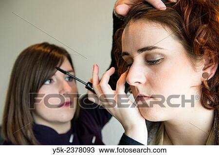 "Tilburg, Netherlands. Young, brunette beautician applying male up to her customers face. " View Large Photo Image Stock Image - "Tilburg, Netherlands. Young, brunette beautician applying male up to her customers face. ". Fotosearch