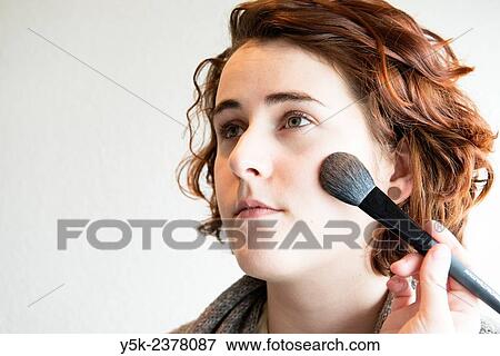 "Tilburg, Netherlands. Young, brunette beautician applying male up to her customers face. " View Large Photo Image Stock Photo - "Tilburg, Netherlands. Young, brunette beautician applying male up to her customers face. ". Fotosearch