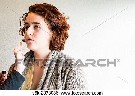 "Tilburg, Netherlands. Young, brunette beautician applying male up to her customers face. " View Large Photo Image Stock Photograph - "Tilburg, Netherlands. Young, brunette beautician applying male up to her customers face. ". Fotosearch
