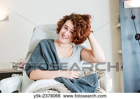 Stock Photograph - "Tilburg, Netherlands. Young, attractive woman waking up after a beauty treatment in a beauty salon. ". Fotosearch