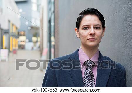 "Tilburg, Netherlands. Young woman, dressed up as a man, standing in front of a concrete wall near main street. " View Large Photo Image Stock Image - "Tilburg, Netherlands. Young woman, dressed up as a man, standing in front of a concrete wall near main street. ". Fotosearch