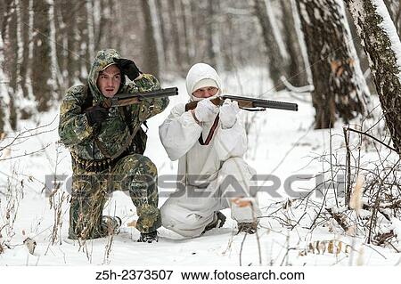 Stock Photo - Winter hunting in a camouflage suit. Belgorod region.. Fotosearch
