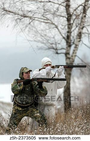 Stock Photography - Winter hunting in a camouflage suit. Belgorod region.. Fotosearch