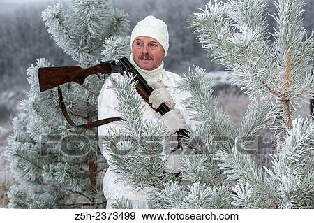 Stock Photo - Winter hunting in white camouflage suit. Belgorod region.. Fotosearch