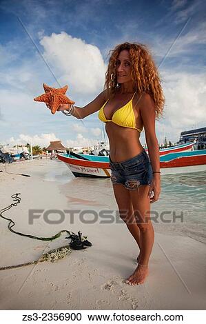 "Woman holding a starfish on the beach, Isla Mujeres, Cancun, Quintana Roo, Yucatan Province, Mexico, Central America. " View Large Photo Image Stock Image - "Woman holding a starfish on the beach, Isla Mujeres, Cancun, Quintana Roo, Yucatan Province, Mexico, Central America. ". Fotosearch
