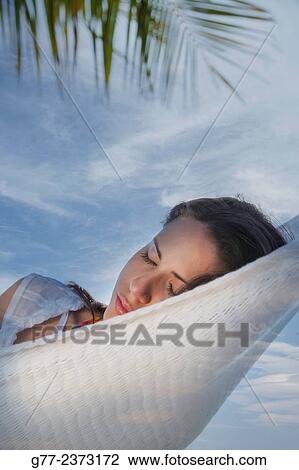 Stock Image - "Woman in a hammock. Miami Beach, Florida, USA". Fotosearch