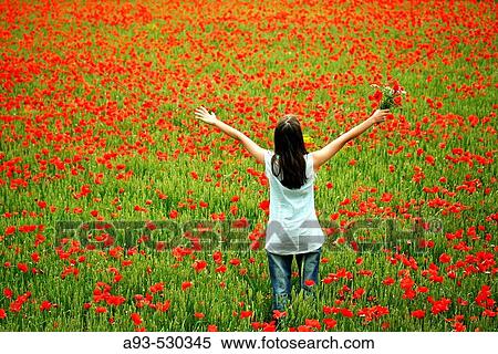 Stock Photography - Woman lying on a poppies field. Fotosearch