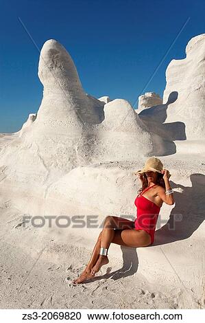 Stock Image - "Woman posing in Sarakiniko beach, Milos, Cyclades Islands, Greek Islands, Greece, Europe. ". Fotosearch