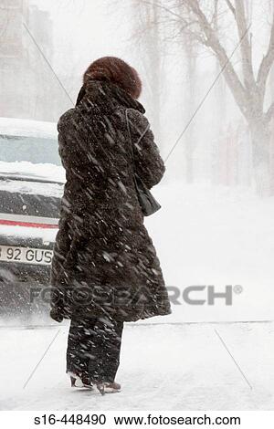 "Woman standing in the street during a blizzard - Bucharest, Romania" View Large Photo Image Stock Image - "Woman standing in the street during a blizzard - Bucharest, Romania". Fotosearch