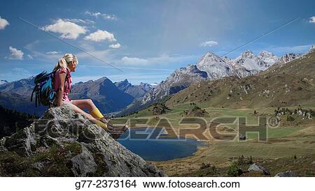 Picture - "Woman watching an alpine lake, Lai da Vons, Canton of Graubünden, Switzerland". Fotosearch