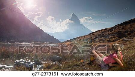 Stock Image - "Woman watching Matterhorn, Riffelsee, Cantos Wallis, Switzerland". Fotosearch