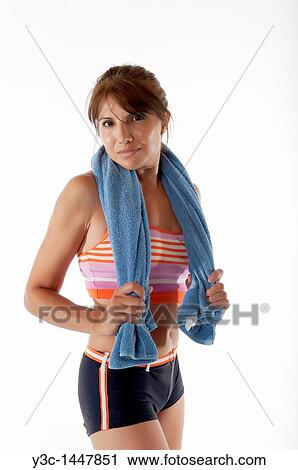 Stock Image - Woman with towel exhausted after fitness exercise. Fotosearch