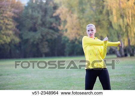 Young blonde woman doing gymnastics in park View Large Photo Image Picture - Young blonde woman doing gymnastics in park. Fotosearch