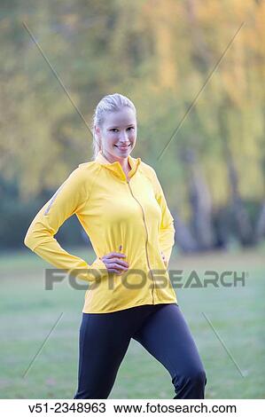 Young blonde woman doing gymnastics in park View Large Photo Image Stock Image - Young blonde woman doing gymnastics in park. Fotosearch