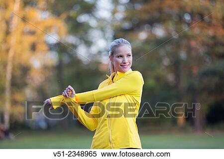 Young blonde woman doing gymnastics in park View Large Photo Image Stock Photography - Young blonde woman doing gymnastics in park. Fotosearch