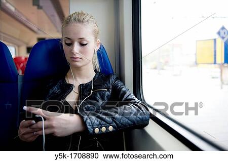 "Young, blonde woman, traveling by train from Rotterdam to Nieuwerkerk. " View Large Photo Image Stock Image - "Young, blonde woman, traveling by train from Rotterdam to Nieuwerkerk. ". Fotosearch