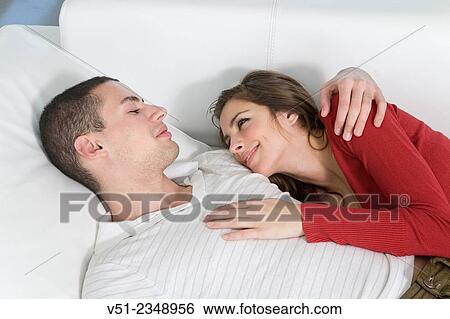 Stock Photograph - Young couple in love on the sofa. Fotosearch