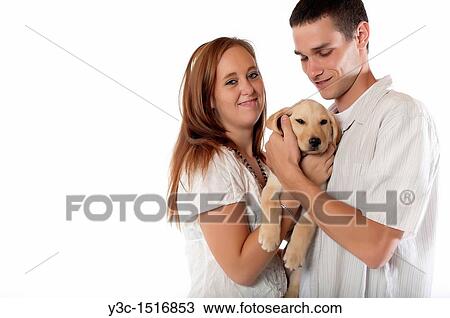 Young couple with labrador retriever puppy View Large Photo Image Stock Image - Young couple with labrador retriever puppy. Fotosearch