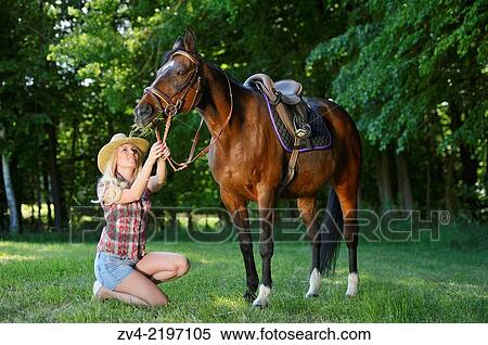 Young cowgirl beside a polish arabian horse on a meadow. View Large Photo Image Stock Photography - Young cowgirl beside a polish arabian horse on a meadow.. Fotosearch