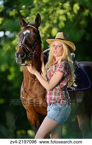 Young cowgirl standing beside a polish arabian horse. View Large Photo Image Stock Photograph - Young cowgirl standing beside a polish arabian horse.. Fotosearch