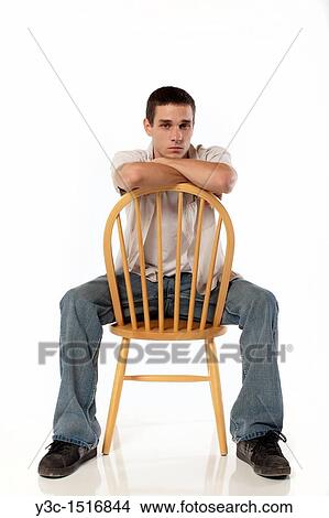 Young man on a chair View Large Photo Image Picture - Young man on a chair. Fotosearch